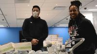 Two simulation team members donate supplies.